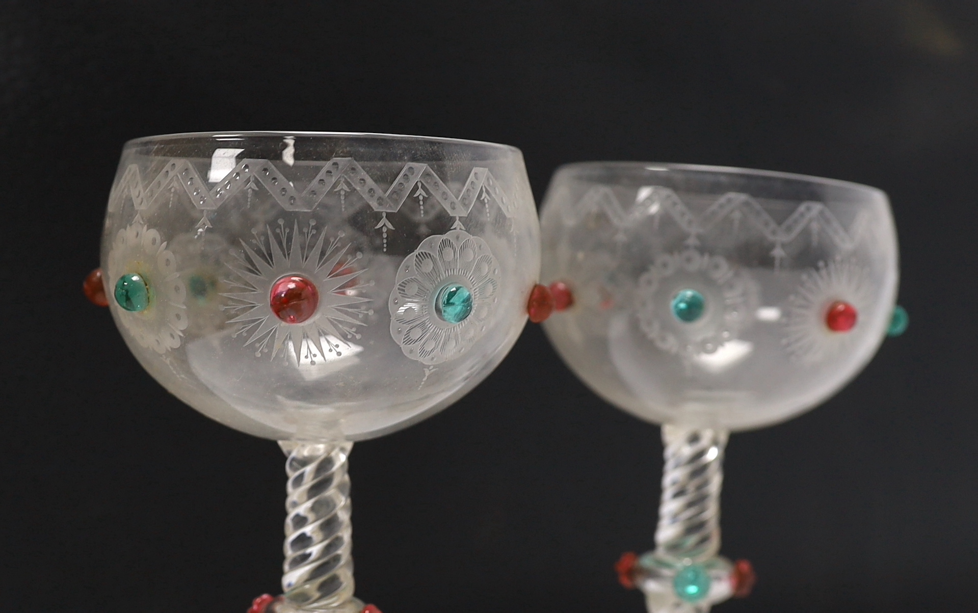A pair of unusual Bohemian wheel engraved glass roemers with applied red and green glass prunts, possibly Moser and two vine engraved rummers, tallest 17cm